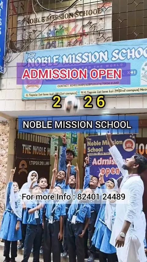 Students and a staff member looking up at a football outside The Noble Mission School Campus 1 entrance