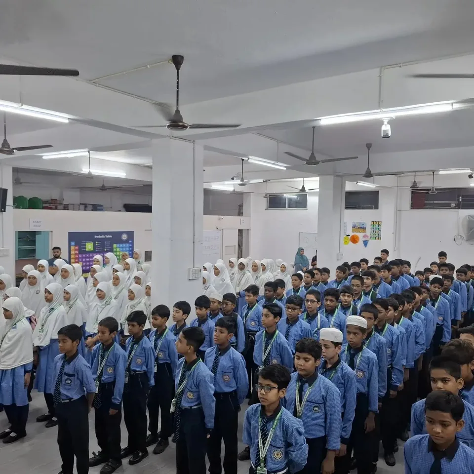 Close view of NMS students in blue uniforms standing in formation at morning assembly