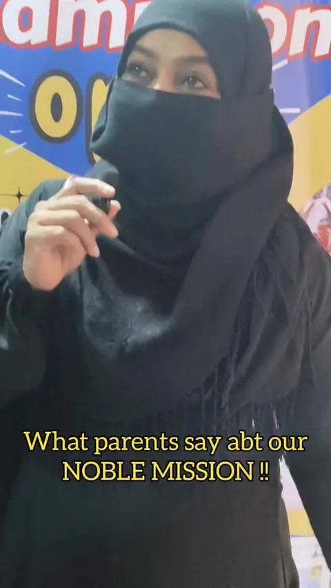 Parent speaking into a microphone during PTM Day at The Noble Mission School